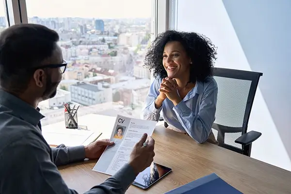 African American man and women sitting at a desk for an interview