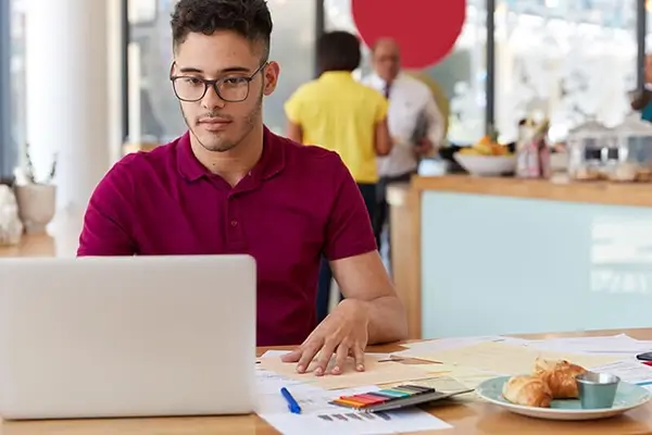 Hispanic man at a laptop 