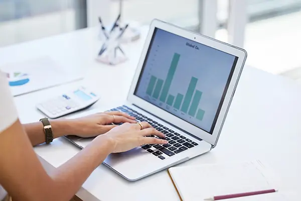 businesswoman-using-her-laptop-to-compile-data