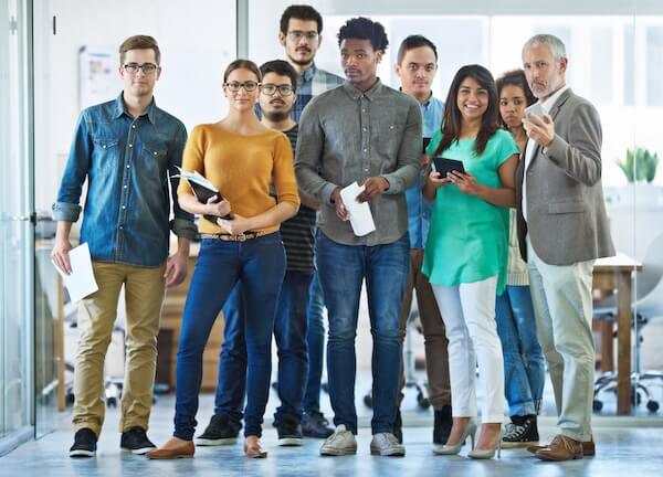 Portrait of a diverse group of coworkers standing in an office. Group of diverse coworkers
