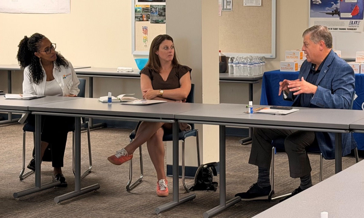 Cheryl Taylor and Adrienne Johnston talk with FSCJ President Dr. John Avendano at Cecil Field